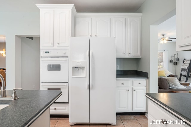 kitchen featuring white cabinets, ceiling fan, white appliances, and light tile patterned floors