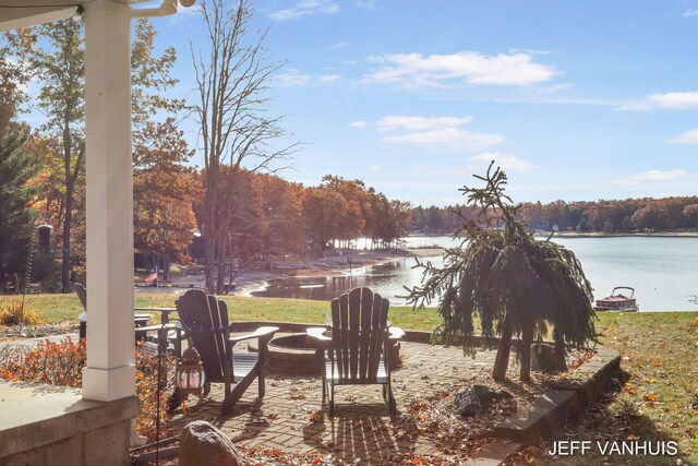 view of yard featuring a fire pit and a water view