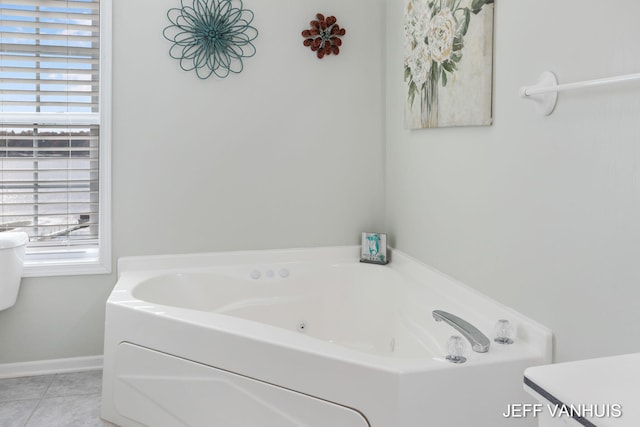 bathroom with tile patterned floors and a washtub