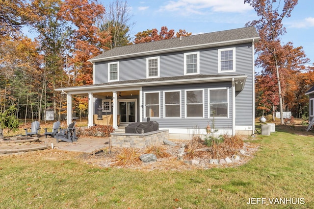 view of front of home with a patio area, a front yard, and central AC unit