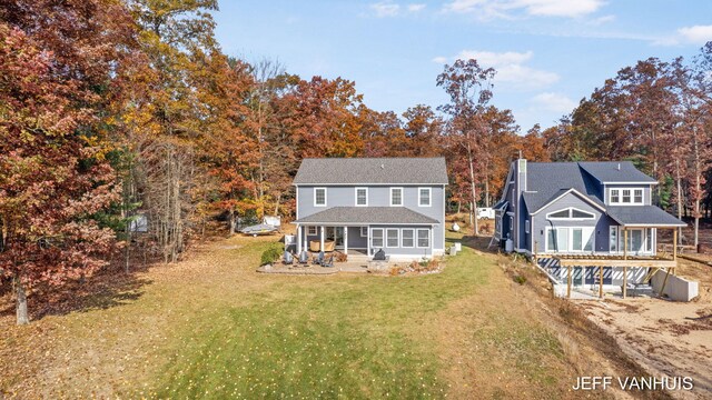 rear view of property featuring a yard