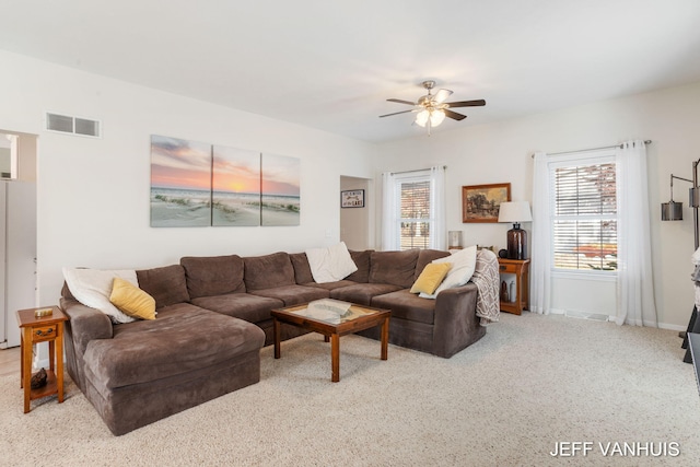 carpeted living room featuring ceiling fan