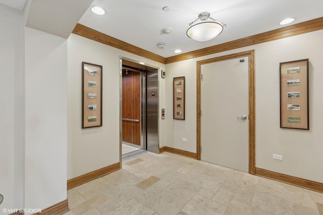 hall with elevator and crown molding