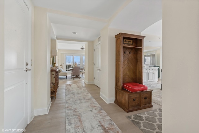 hallway with light hardwood / wood-style flooring