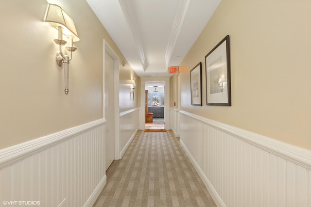 hallway featuring light colored carpet and crown molding