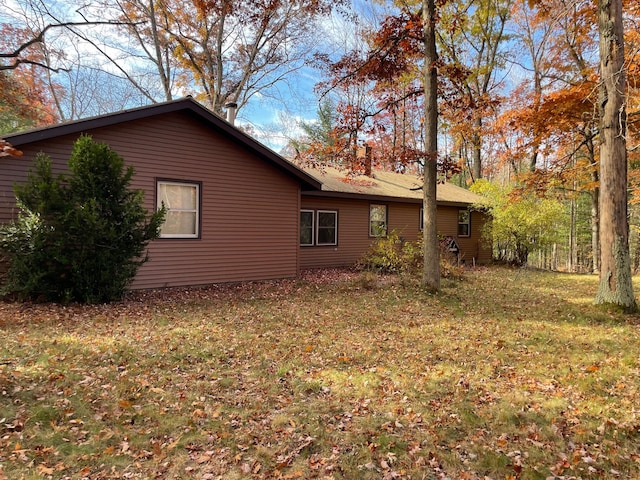 view of home's exterior with a lawn