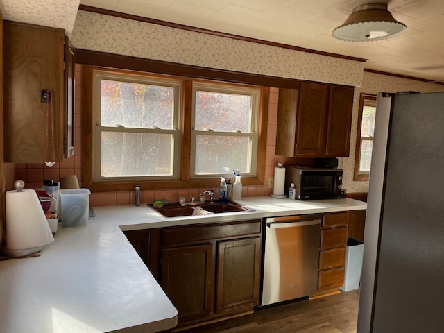 kitchen with stainless steel appliances, sink, and plenty of natural light