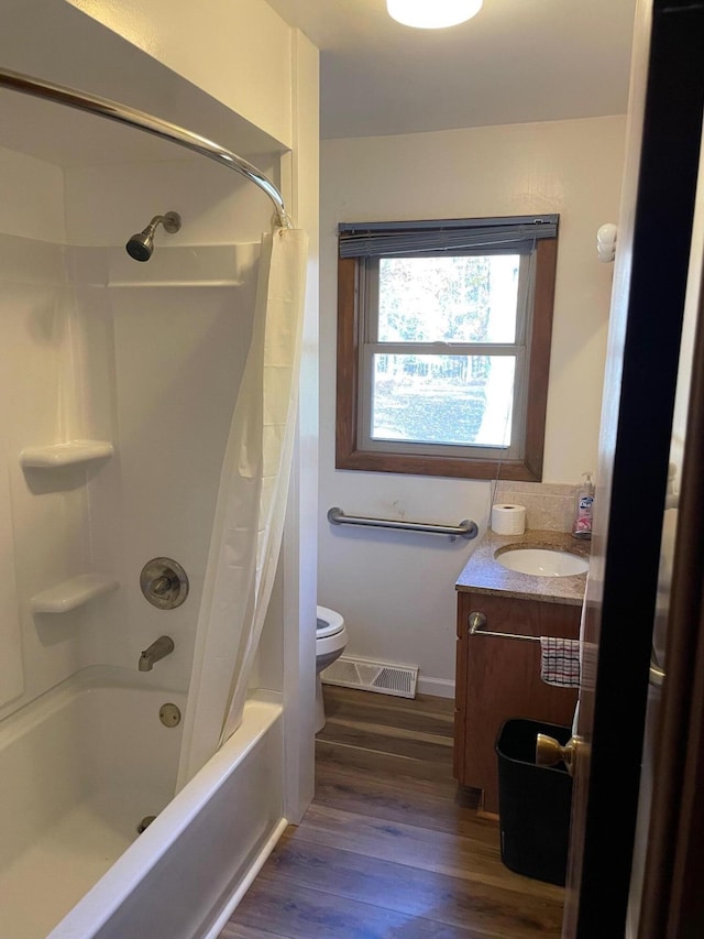 full bathroom featuring toilet, hardwood / wood-style flooring, vanity, and shower / bath combination with curtain