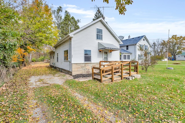 rear view of house with a yard