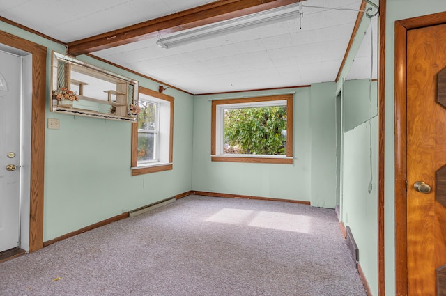 carpeted spare room featuring beam ceiling and a baseboard radiator