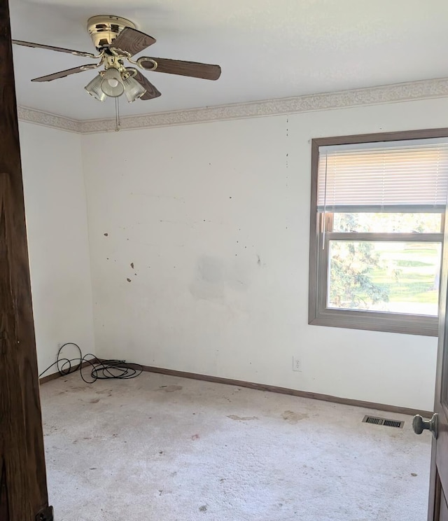 carpeted spare room with ceiling fan