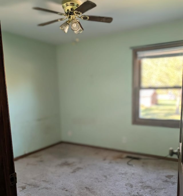 empty room with light carpet and ceiling fan