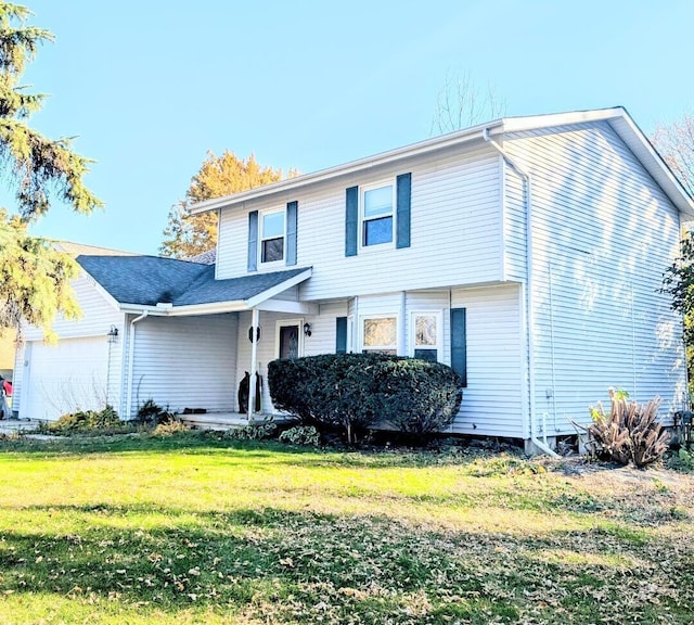 front facade featuring a front yard and a garage