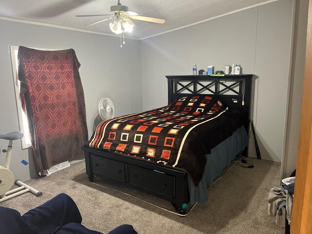 bedroom featuring ornamental molding, a textured ceiling, carpet flooring, and ceiling fan