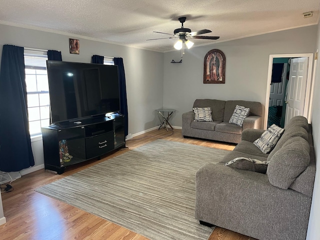 living room with ornamental molding, hardwood / wood-style floors, a textured ceiling, and ceiling fan