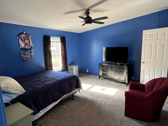 carpeted bedroom with ceiling fan and a textured ceiling