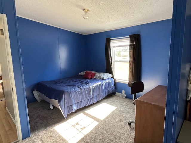 carpeted bedroom with a textured ceiling