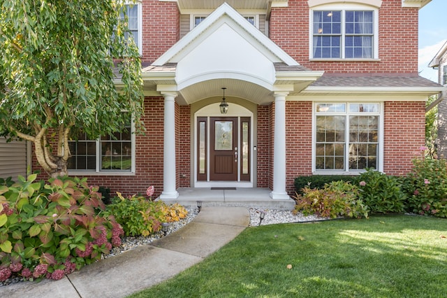 property entrance with a yard