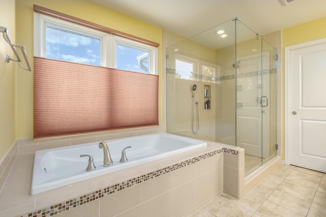 bathroom with tile patterned floors and separate shower and tub