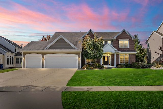 view of front of home with a lawn and a garage