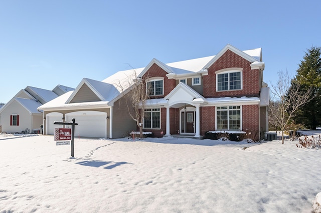 view of front of property with central AC unit and a garage