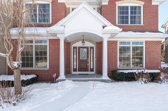 view of snow covered property entrance