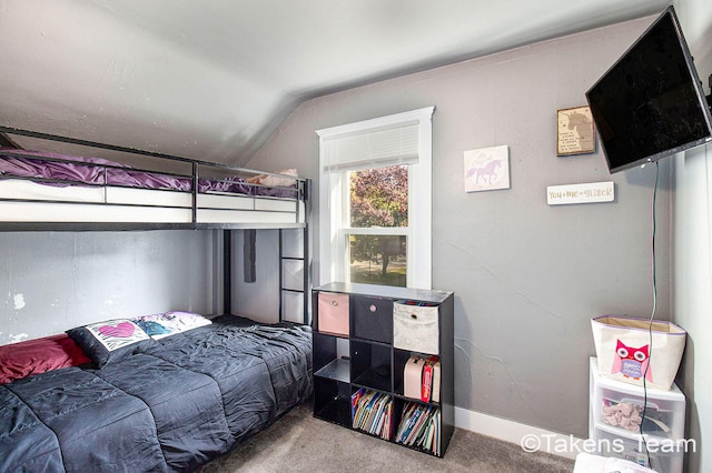 carpeted bedroom featuring lofted ceiling