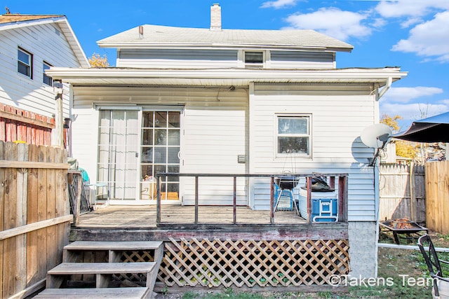 back of property with a wooden deck