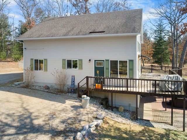 rear view of house featuring a deck