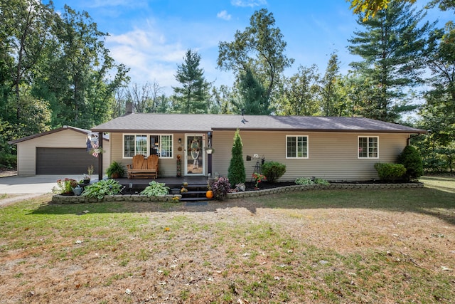 single story home with a front yard, an outdoor structure, and a garage