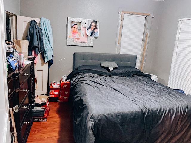 bedroom with dark wood-type flooring