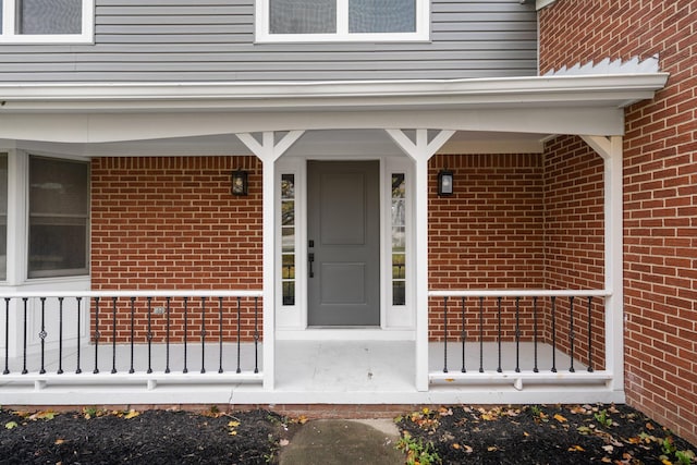 view of exterior entry with covered porch