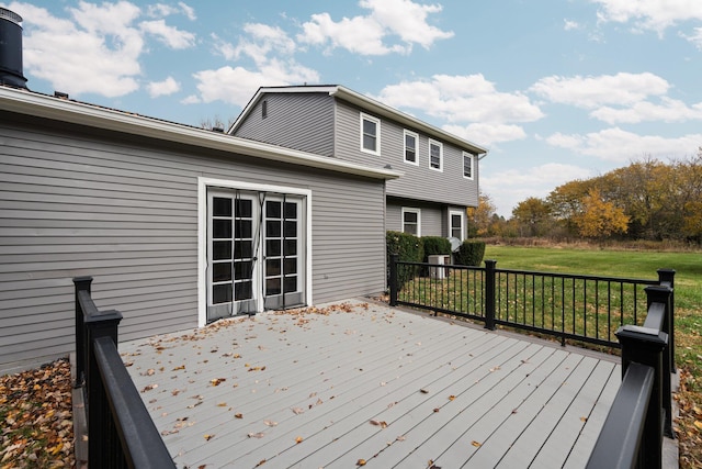 wooden deck featuring a lawn