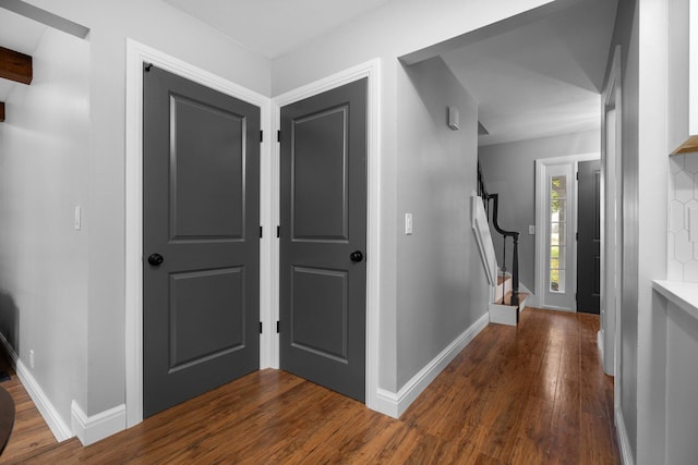 entryway with beamed ceiling and dark hardwood / wood-style flooring