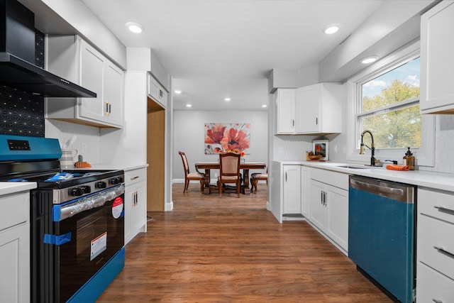 kitchen featuring white cabinets, wall chimney range hood, and stainless steel appliances