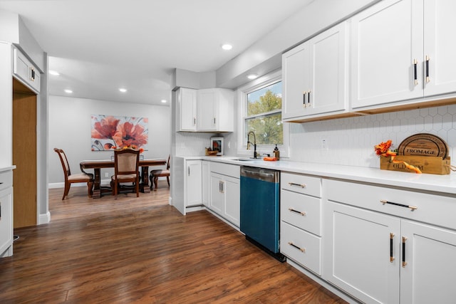 kitchen with white cabinets, tasteful backsplash, stainless steel dishwasher, dark hardwood / wood-style floors, and sink