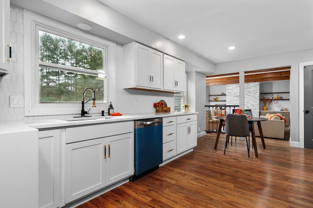 kitchen featuring sink, backsplash, white cabinetry, stainless steel dishwasher, and dark hardwood / wood-style floors