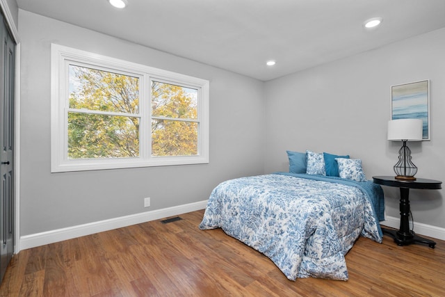 bedroom with hardwood / wood-style flooring and a closet