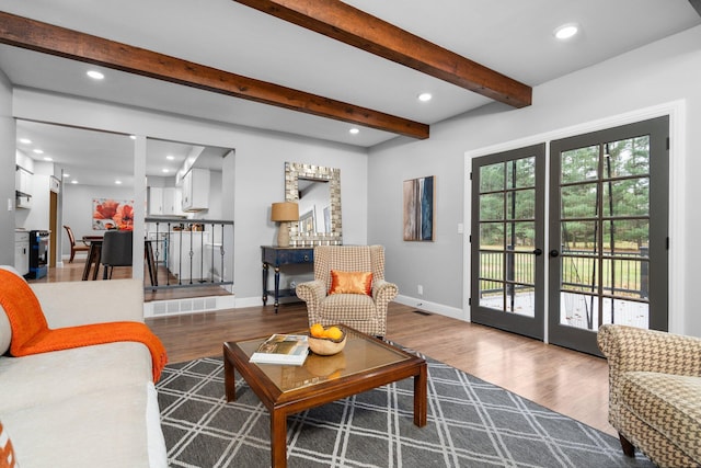 living room with french doors, hardwood / wood-style floors, and beam ceiling