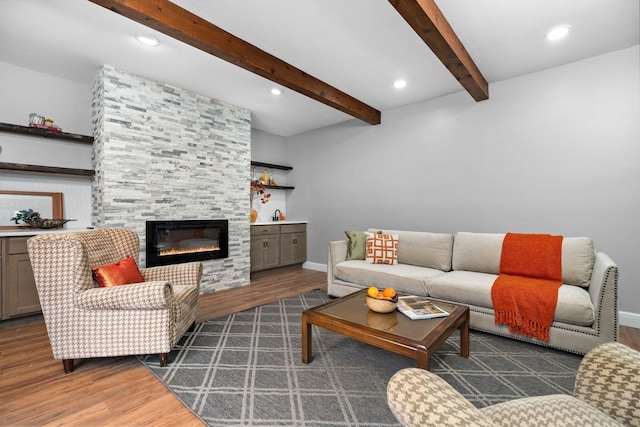 living room with beam ceiling, a fireplace, and dark hardwood / wood-style flooring