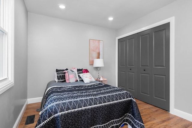 bedroom featuring hardwood / wood-style floors and a closet