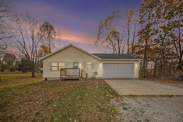 view of front of property featuring a yard and a garage