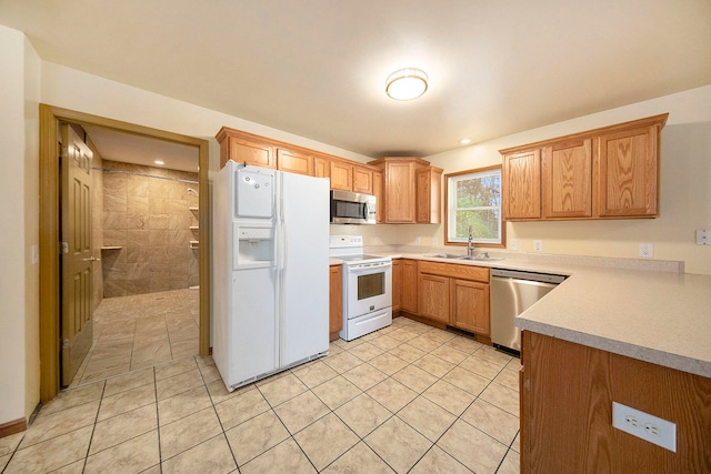 kitchen featuring light tile patterned floors, appliances with stainless steel finishes, and sink