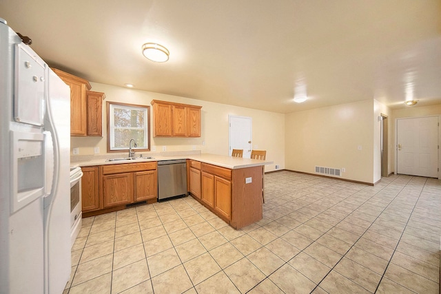 kitchen with white appliances, light tile patterned floors, sink, and kitchen peninsula