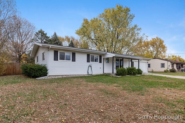 ranch-style home with a front yard and a garage