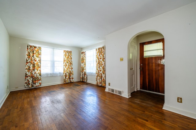 empty room featuring dark wood-type flooring