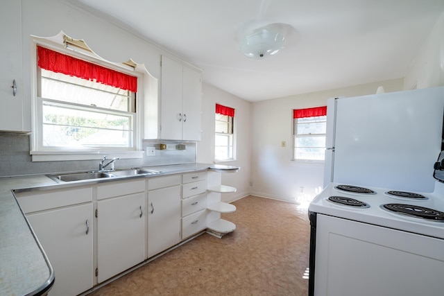 kitchen with a healthy amount of sunlight, white cabinetry, sink, and white appliances