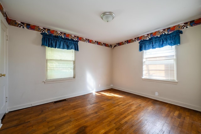 unfurnished room with wood-type flooring