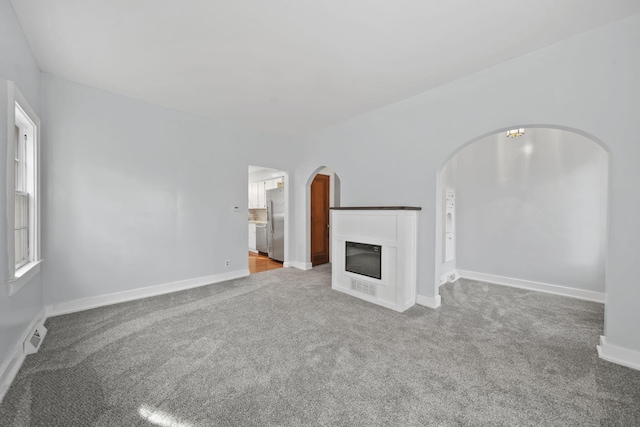 unfurnished living room featuring carpet floors