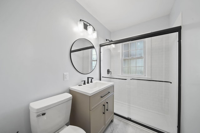 bathroom featuring vanity, toilet, and an enclosed shower